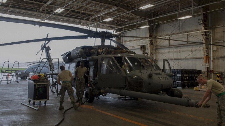 Airmen with the 33rd Helicopter Maintenance Unit complete a fuel probe inspection June 14, 2016, at Kadena Air Base, Japan. The fuel probe was tested for its stress limits during in-flight refueling procedures. (U.S. Air Force photo by Airman 1st Class Lynette M. Rolen)