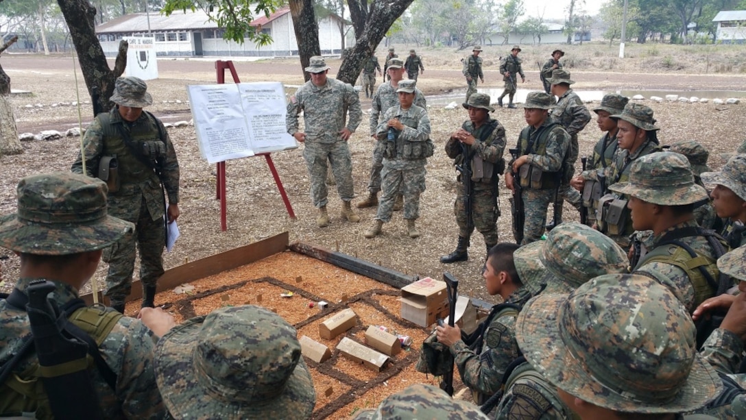 Staff Sgt. Bitzer and Spc. Hernandez cover terrain models during a class on troop-leading procedures with Reconaissance Soldiers from the 1st Infantry Brigade on May 12, 2016.