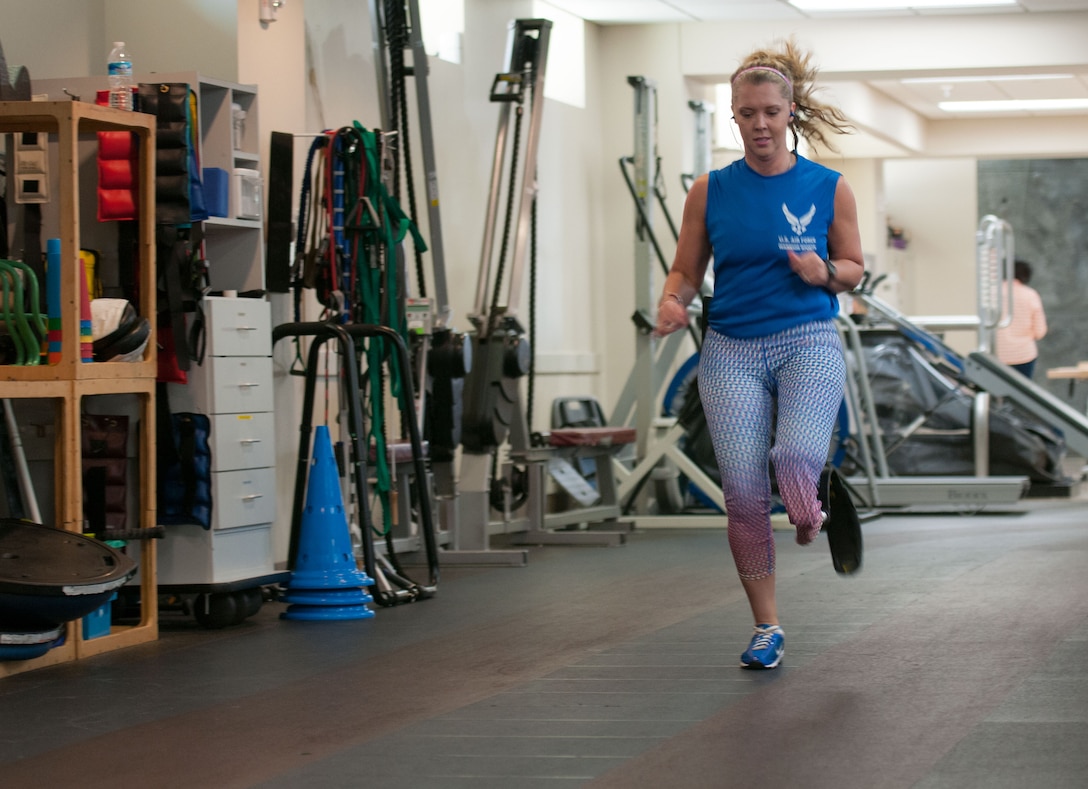 Heather Carter, an above-knee amputee, runs laps around a track inside the Military Advanced Training Center at Walter Reed National Military Medical Center in Bethesda, Md., April 13, 2016. Carter, a medically retired senior airman, and other amputees receive physical and occupational therapy at the center as they work toward their goals. One of Carter’s goals is to return to competitive softball. (U.S. Air Force photo/Sean Kimmons)