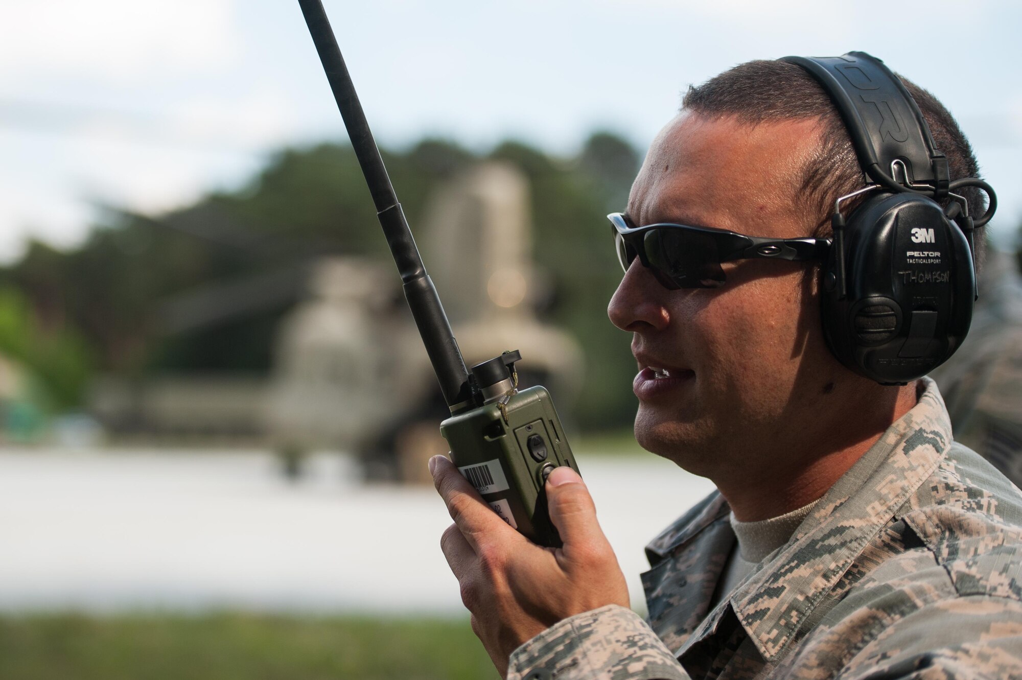 Tech. Sgt. Mitchell Thompson, 921st Contingency Response Squadron ramp coordinator, talks to other members of the Contingency Response Team while off loading CH-47 Chinook helicopters during Exercise Swift Response 16 at Bydgoszcz Airport, Poland, June 8, 2016. Contingency Response units are self-sufficient and can deploy with all personnel, equipment and supplies to execute the mission. (U.S. Air Force photo by Master Sgt. Joseph Swafford/Released) 