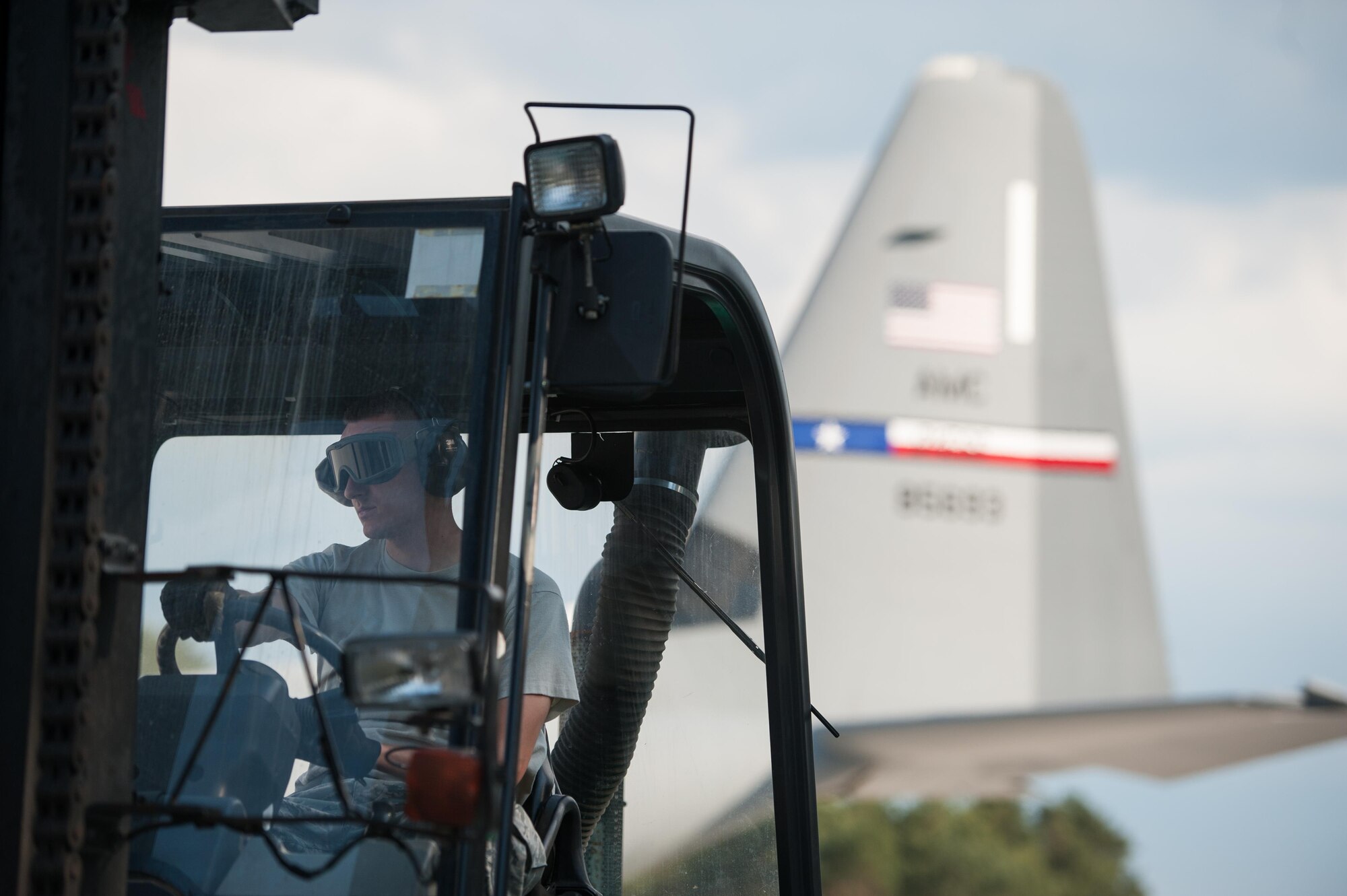 Staff Sgt. Phillip Flores, 921st Contingency Response Squadron aerial port mobility supervisor, offloads pallets from a C-130J Super Hercules during Exercise Swift Response 16 at the Bydgoszcz Airport, Poland, June 8, 2016. Exercise SR16 is one of the premier military crisis response training events for multinational airborne forces in the world, the exercise has more than 5,000 participants from 10 NATO nations. (U.S. Air Force photo by Master Sgt. Joseph Swafford/Released)