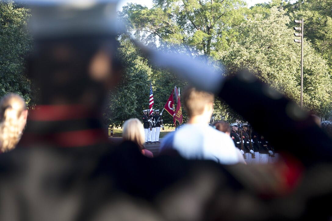 Sgt. Nicholas S. Smith, Marine Barracks Washington, D.C., salutes during the presentation of the colors during the Sunset Parade at the Marine Corps War Memorial, Arlington, Va., Jun. 15, 2016. The guest of honor for the parade was the Honorable Ray Mabus, Secretary of the Navy, and the hosting official was Gen. Robert B. Neller, commandant of the Marine Corps. (Official Marine Corps photo by Cpl. Chi Nguyen/Released)