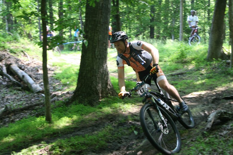 Josh Caufman, 35, navigates his bike down a muddy slope during the 2016 Quantico Cranky Monkey bike race May 28. Caufman was the second place finisher in the Expert Male category of the cross-country event, completing three laps in 2:14:21.