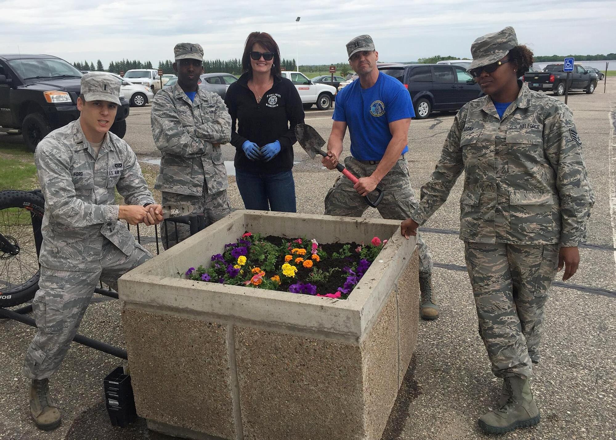 Airmen from the 10th Space Warning Squadron plant flowers in recognition of Arbor Day on June 3, 2016 at Cavalier Air Force Station, N.D. The day’s events consisted of the Tree City U.S.A. presentation, flower and tree planning, a site picnic and the ceremonial first watering. (Courtesy photo)