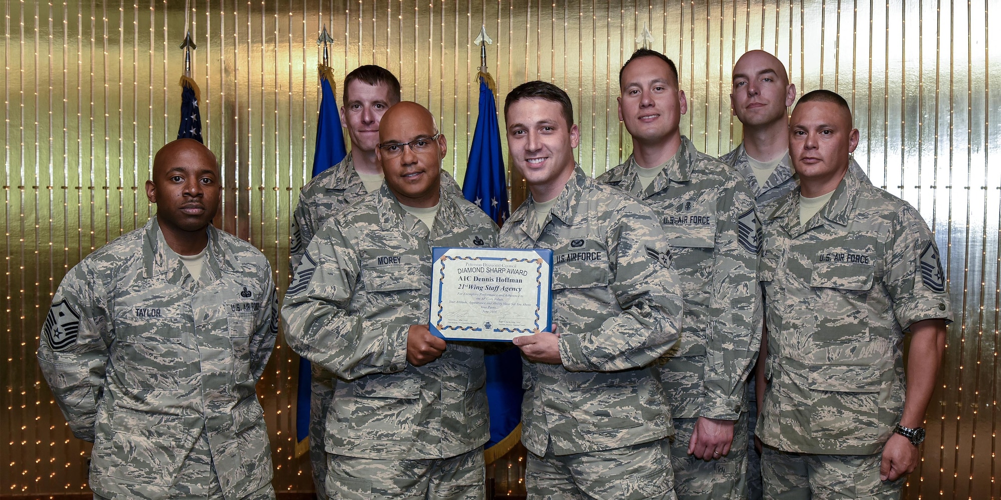 Airman 1st Class Dennis Hoffman, 21st Space Wing Public Affairs, is presented the Diamond Sharp Award by the Peterson Diamond Council June 14, 2016. The Diamond Sharp award is presented by the Peterson Diamond Council and recognizes superior performers. (U.S. Air Force photo by Craig Denton)