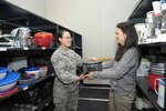 Kelli Franklin (right), Joint Base San Antonio-Randolph Military & Family Readiness Center community readiness consultant, provides a microwave to Airman 1st Class Yan Cui from the Loan Locker June 8 at JBSA-Randolph. The Loan Locker provides temporary loans of household items to incoming and departing permanent party personnel. 