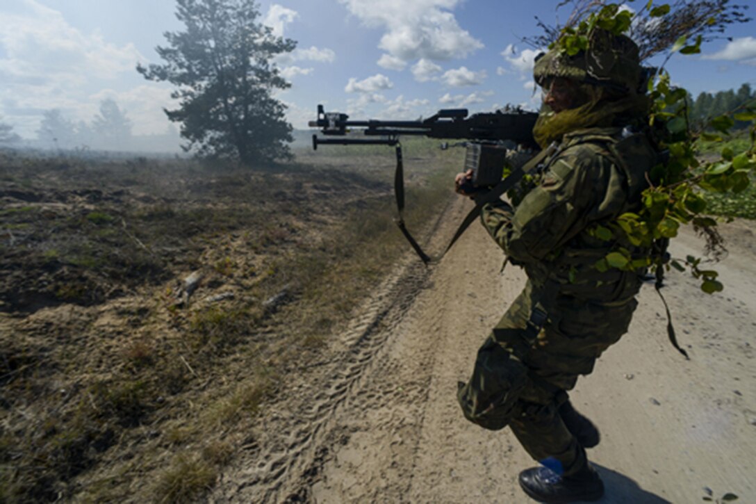 A Norwegian soldier attacks opposing forces during a training exercise at Adazi Military Training Base, Latvia, June 13, 2016. U.S. Air Force photo by Senior Airman Nicole Keim