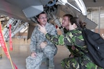 Romanian air force 2nd Lt. Chirila Sandu, right, and Romanian air force Maj. Constantin Pecete talk with U.S. Air Force Senior Master Sgt. William Rhodes, avionics element superintendent with the 187th Maintenance Squadron, about a U.S. Air National Guard F-16 Fighting Falcon aircraft June 8, 2016, in the hangar at the Montgomery Regional ANGB, Ala. 