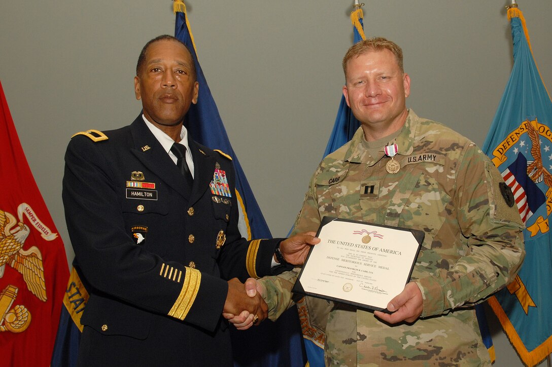 Army Captain Capt. Franklin Carr receives a Defense Meritorious Service Award from Army Brig. Gen. Charles Hamilton, Defense Logistics Agency Troop Support commander, during a quarterly awards ceremony June 14. 