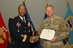 Army Captain Capt. Franklin Carr receives a Defense Meritorious Service Award from Army Brig. Gen. Charles Hamilton, Defense Logistics Agency Troop Support commander, during a quarterly awards ceremony June 14. 