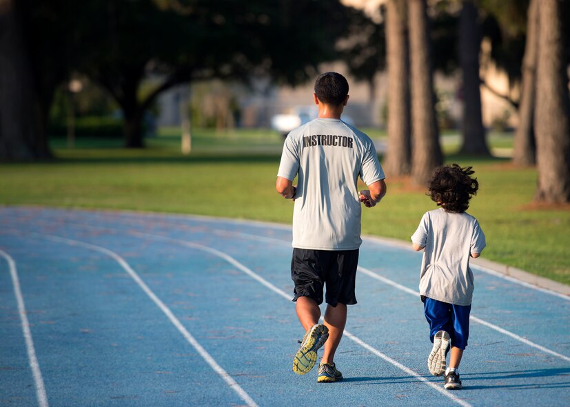 U.S. Air Force Tech. Sgt. Don Bustamante, 372nd Training Squadron A-10 avionics instructor and his son Cameron, jog during the Tiger Run, June 11, 2016, at Moody Air Force Base, Ga. Participants of all ages came out and ran to raise money for Moody’s 2016 Air Force Assistance Fund which supports charitable affiliates that help Air Force families. (U.S. Air Force photo by Airman 1st Class Janiqua P. Robinson/Released)