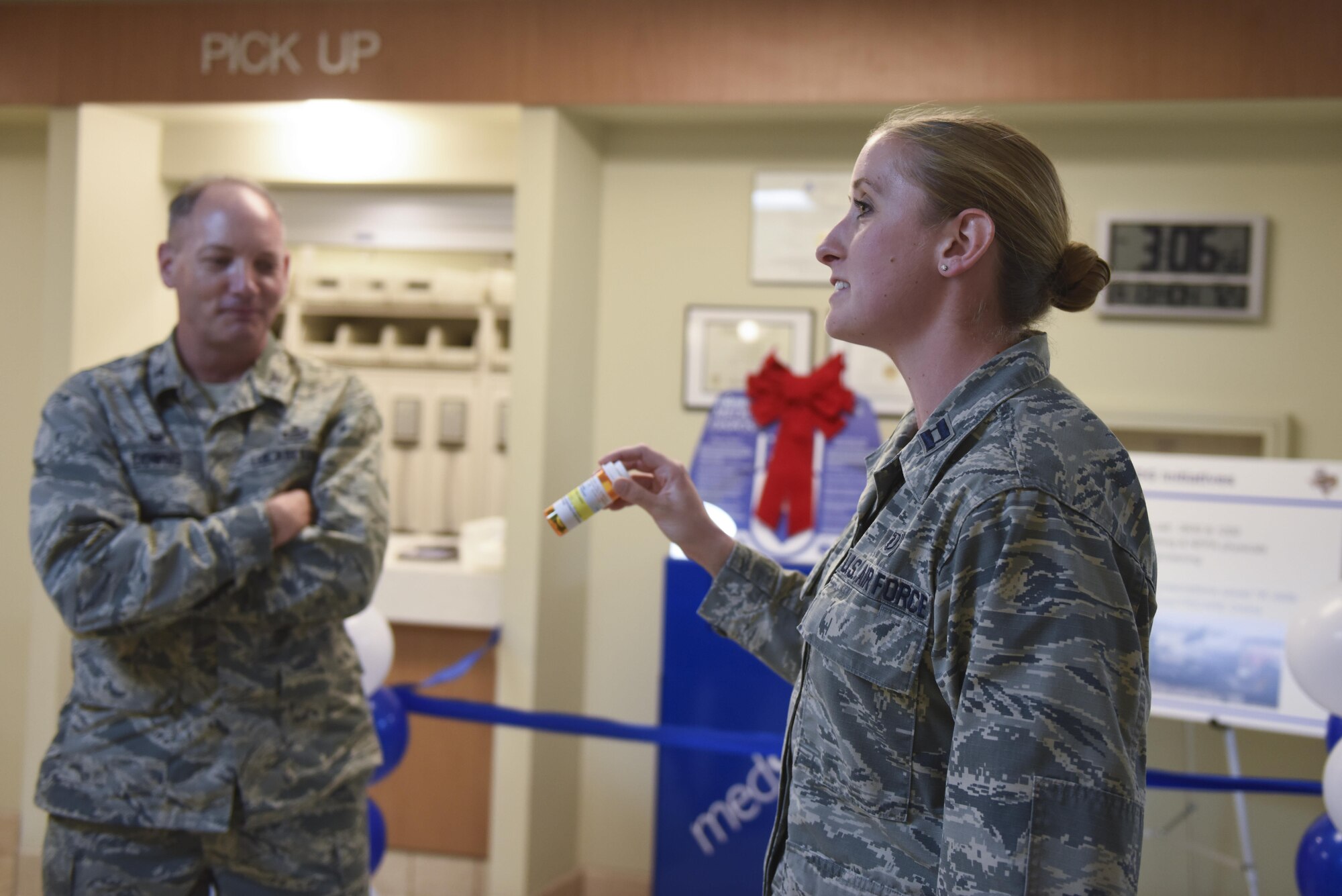 U.S. Air Force Col. Michael Downs, 17th Training Wing Commander, and Capt. Aubrie Wnek, 17th Medical Support Squadron pharmacy element chief, talk about the new capability to turn in unused prescription medication year round using the new medsafe drop box during a ribbon cutting ceremony at the Ross Medical Clinic Pharmacy on Goodfellow Air Force Base, Texas, June 13, 2016. Previously, the clinic hosted two prescription turn-ins a year. (U.S. Air Force photo by Airman 1st Class Chase Sousa/Released)