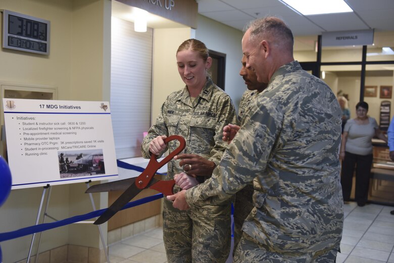U.S. Air Force Capt. Aubrie Wnek, 17th Medical Support Squadron pharmacy element chief, Lt. Col. Bernard VanPelt, 17th MDSS Commander, and Col. Michael Downs, 17th Training Wing Commander, cut the ribbon during the ceremony for the new medsafe drop box at the Ross Medical Clinic Pharmacy on Goodfellow Air Force Base, Texas, June 13, 2016. Goodfellow members can now turn in unused prescription medication year round. (U.S. Air Force photo by Airman 1st Class Chase Sousa/Released)