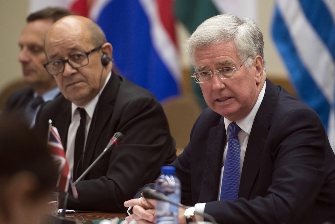 British Defense Secretary Michael Fallon, right, makes opening remarks during a meeting with French Defense Minister Jean-Yves Le Drian, foreground left, and Defense Secretary Ash Carter, not shown, at NATO headquarters in Brussels, June 14, 2016. The three leaders met to discuss matters of mutual interest. DoD photo by Air Force Senior Master Sgt. Adrian Cadiz