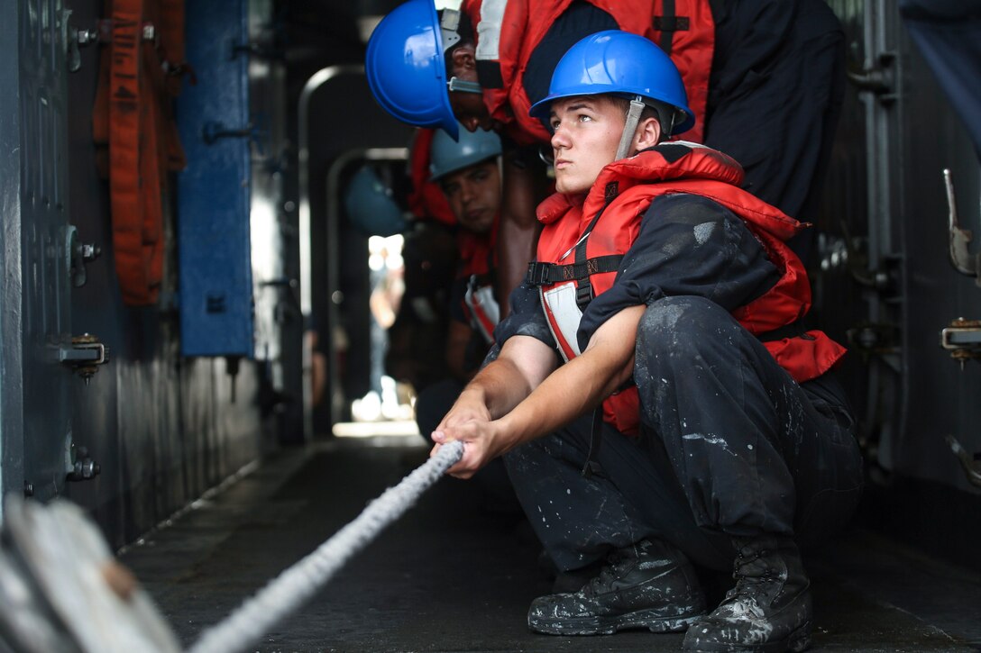 Sailors and Marines aboard the USS Ashland pull a supply rope during Cooperation Afloat Readiness and Training, or CARAT, in the Gulf of Thailand, June 14, 2016. CARAT is a series of annual maritime exercises between the U.S. Navy, the U.S. Marine Corps and the armed forces of Bangladesh, Brunei, Cambodia, Indonesia, Malaysia, Singapore, the Philippines, Thailand and East Timor. Marine Corps photo by Lance Cpl. Carl King Jr.