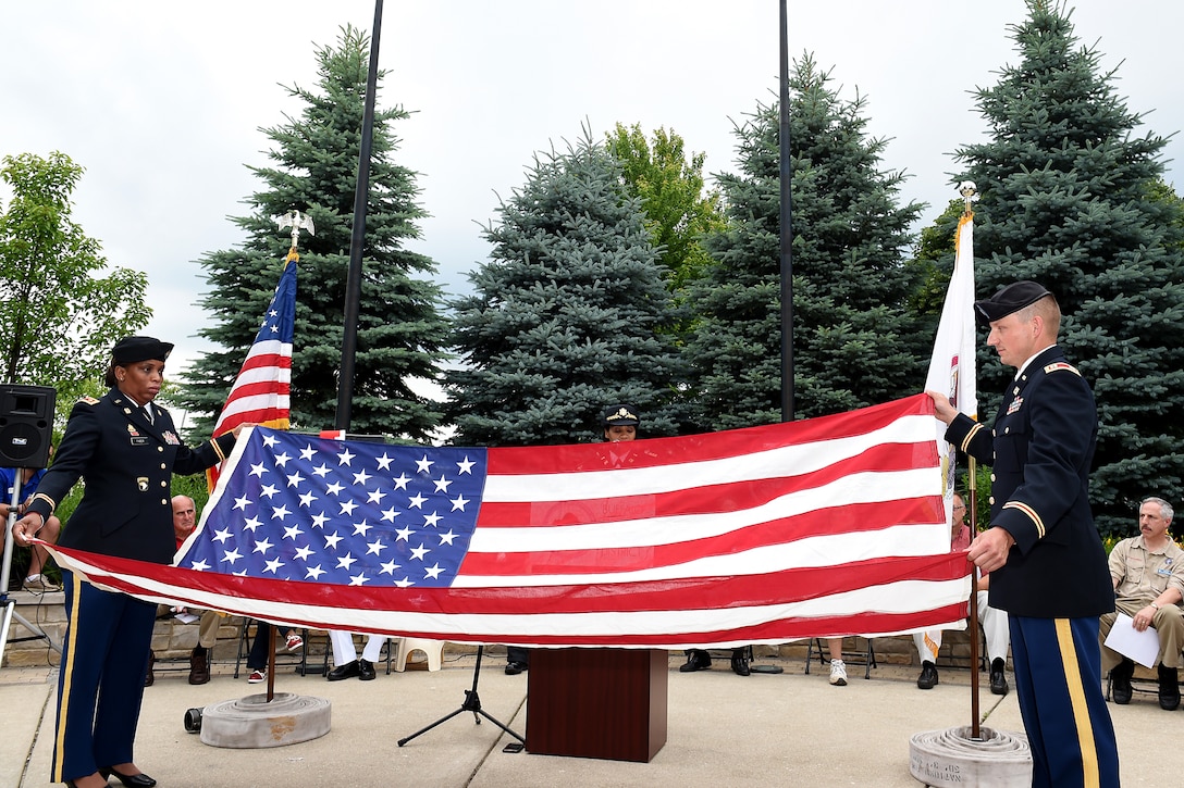 Army Reserve Maj. Erna Faber, Chief of Operation and Plans, 85th Support Command, left, and Capt. Jason Smigelski, Individual Training Officer, 85th Support Command, present the American flag before folding it during a flag folding ceremony, at the Flag Day ceremony in Buffalo Grove, Illinois, June 14, 2016.
(U.S. Army photo by Sgt. Aaron Berogan/Released)