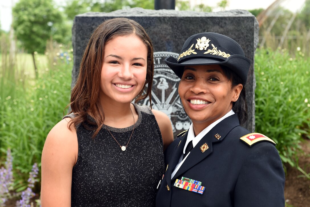 Brianna Van Zanten, left, and her mother Army Reserve Lt. Col. Priscilla Van Zanten, Equal Opportunity Advisor to the General, Great Lakes Training Division, 75th Training Command, pause for a photo in front of an Army memorial rock at Veterans Park in Buffalo Grove, Illinois after a Flag Day ceremony there, June 14, 2016. Brianna Van Zanten was the vocalist for the ceremony singing the National Anthem. 
(U.S. Army photo by Sgt. Aaron Berogan/Released)