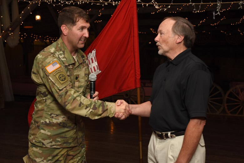 Lt. Col. Stephen Murphy, U.S. Army Corps of Engineers Nashville District commander, congratulates Johnny Wilmore Jr., former Construction Branch chief, while presenting him the Distinguished Civilian Employees Award during Engineering Day Picnic festivities at Smiley Hollow in Ridgetop, Tenn., June 10, 2016. Wilmore culminated a 40-year career with the Corps of Engineers in November 2013.