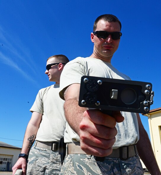 Senior Airman Troy Adams, 2nd Civil Engineer Squadron heating ventilation and air conditioning systems technician, uses a radiation scanner during a decontamination exercise at Barksdale Air Force Base, La., June 6, 2016. The intent of the decontamination process is to help people who have come into contact with radioactive material to ditch their gear without contaminating themselves or others. (U.S. Air Force photo/Senior Airman Luke Hill)