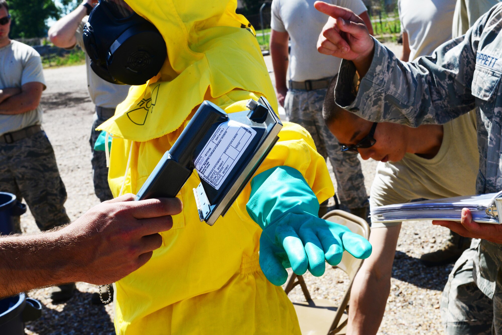 Airmen check for radiation during a decontamination training exercise for the emergency management support team at Barksdale Air Force Base, La., June 6, 2016. Keeping the EMST up to speed enables emergency management to respond quicker and more efficiently. (U.S. Air Force photo/Senior Airman Luke Hill)