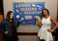 Bailey Tetrault and Liana Vargas display the 2016 Summer Reading Program poster at the Tyndall Air Force Base Library, June 15, 2016. This year's theme is “Read for the Win!” and celebrates all types of sports: Olympics, football, gymnastics, outdoor games and more. The six-week program is designed for age groups from 6 months through high school, and is aimed at generating excitement for reading. (U.S. Air Force Photo by Airman 1st Class Cody R. Miller/Released) 