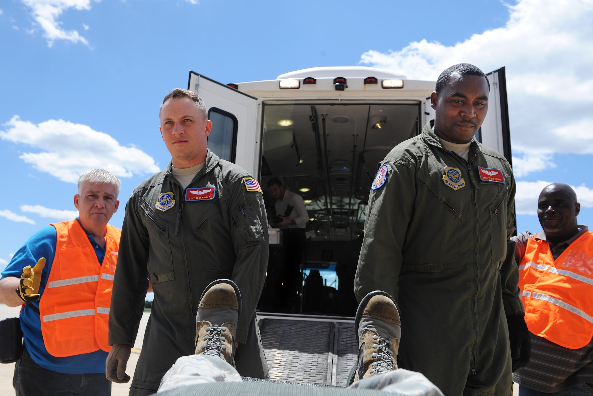Staff Sgt. Alan Bibalo, 375th Aeromedical Evacuation Squadron areomedical evacuation technition, left, and Staff Sgt. Irwin Jones, left, 375th Aeromedical Evacuation Squadron aeromedical evacuation technician, right, carry a "patient" during training June 7, 2016 at the MidAmerica St. Louis Airport in Mascoutah, Illinois.  375th AES servicemembers trained Department of Veteran Affairs personnel on different types of military equipment, because during natural disasters and emergency situations, DMV and other civilian entities will often work with the military to get patients to safe locations. (U.S. Air Force photo by Staff Sgt. Maria Bowman)