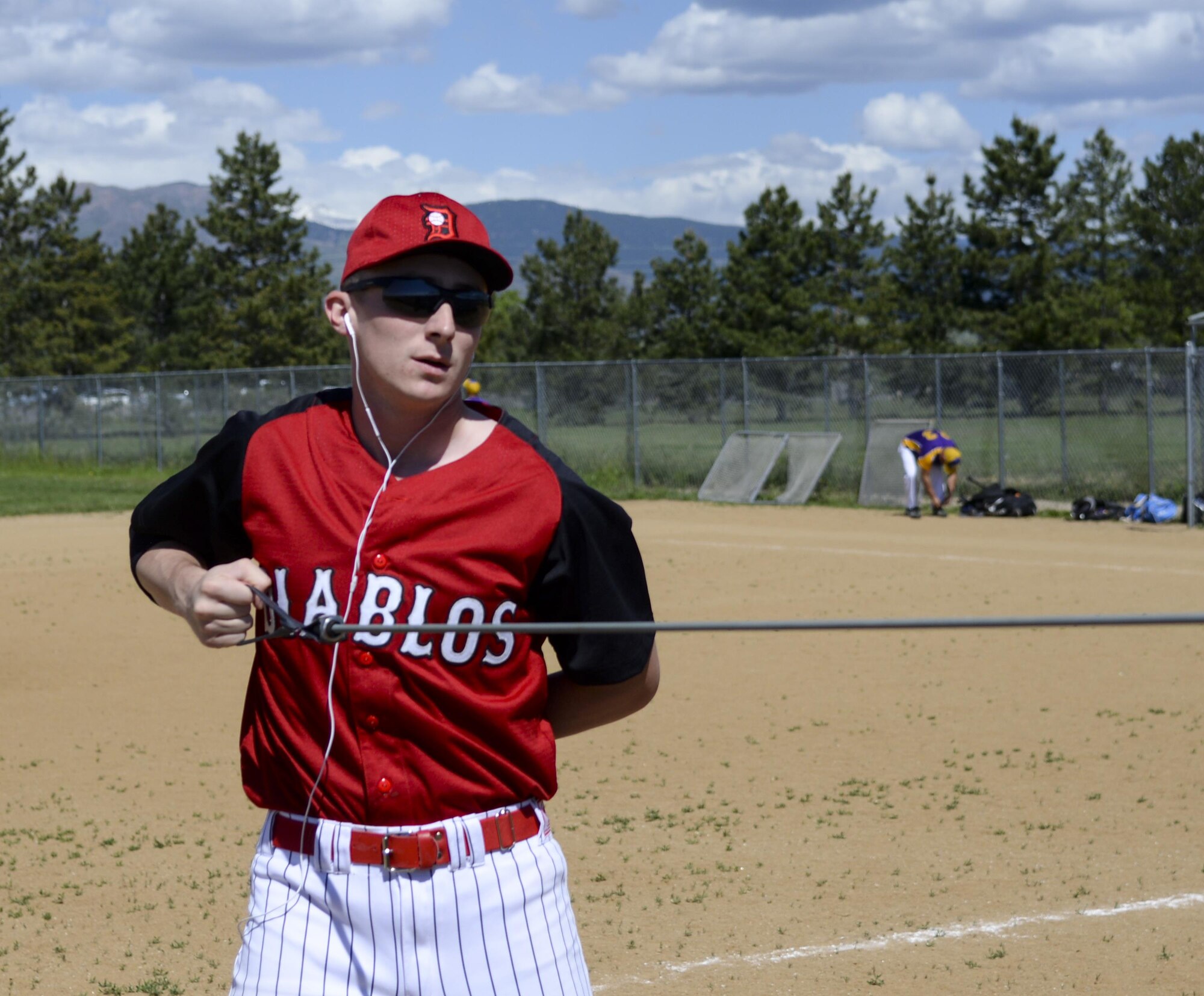 Senior Airman Devin Mooney, 321st Missile Squadron commander's support staff and Personnel Reliability Program monitor, warms up before a game with his Fort Collins league baseball team May 29, 2016, in a field in Colorado. Mooney will try out for a Major League Baseball team in June. (U.S. Air Force photo by Senior Airman Jason Wiese)