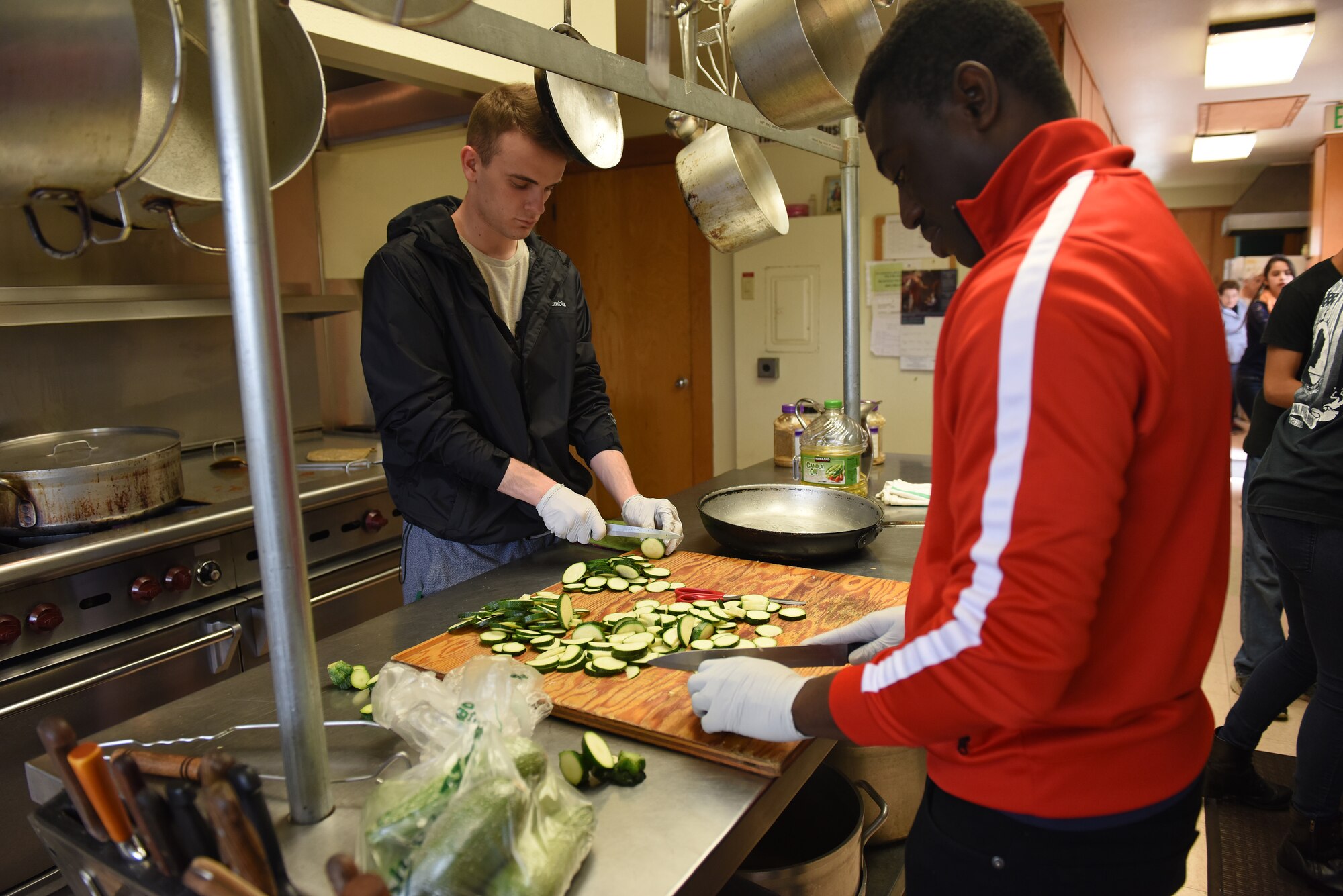 Senior Airmen Cameron Brisson, left, and Daniel Kuma, 30th Medical Operations Squadron bioenvironmental technicians, prepare vegetables for a weekly meal service at the La Purisima Community Kitchen, June 10, 2016. For about 10 years now, volunteer teams from Vandenberg have been working in the kitchen and serving line of the La Purisima Community Kitchen, helping provide weekly meals to those in need. (U.S. Air Force photo by Michael Peterson/Released)