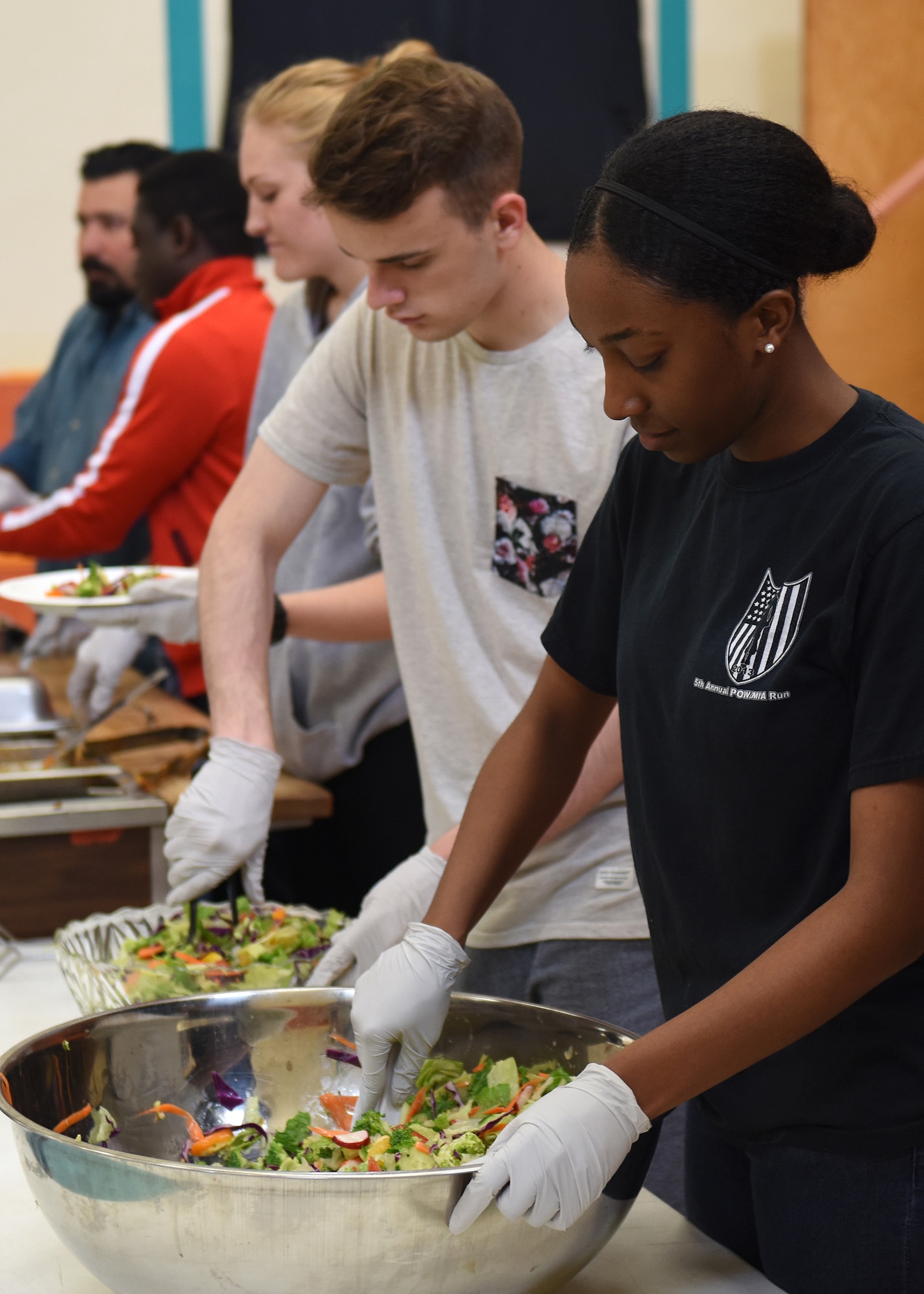 Senior Airman Tamara Brown, 30th Medical Group physical evaluation board liaison officer and current volunteer team leader, works the serving line with her 30th MDG team members at the La Purisima Community Kitchen June 10, 2016. For 10 years now, volunteer teams from Vandenberg have been working in the kitchen and serving line of the La Purisima Community Kitchen, helping provide weekly meals to those in need. (U.S. Air Force photo by Michael Peterson/Released)