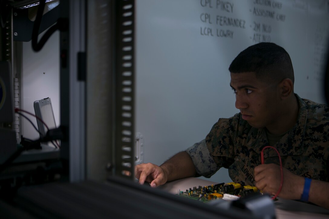 Lance Cpl. Joshua Lowry diagnoses a faulty circuit card on Camp Courtney June 2, 2016. He is pin-pointing where the damaged is located by sending a current through the circuit and watching for a response. Lowry, a Bergen County, New Jersey, native, is a miniature/ micro-miniature technician with Maintenance Platoon, Communications Company, Headquarters Battalion, 3rd Marine Division, III Marine Expeditionary Force. (U.S. Marine Corps photo by Cpl. Tyler Ngiraswei/ Released)