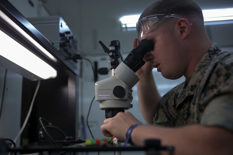 Cpl. Jacob M. Pikey cleans a faulty circuit card on Camp Courtney June 2, 2016. In order for him to repair the card, he must clean it before he begins soldering. Pikey, a Cedar Hill, Missouri, native, is the assistant chief of the miniature/ micro-miniature section for Maintenance Platoon, Communications Company, Headquarters Battalion, 3rd Marine Division, III Marine Expeditionary Force. (U.S. Marine Corps photo by Cpl. Tyler Ngiraswei/ Released)