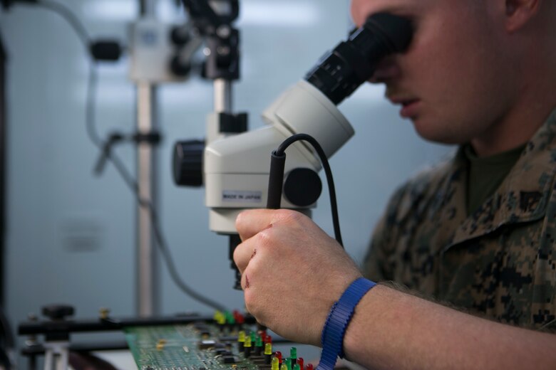 Cpl. Jacob M. Pikey solders a circuit on Camp Courtney, Okinawa, Japan, June 2, 2016. He is repairing a faulty circuit after diagnosing the issue.  Pikey, a Cedar Hill, Missouri, native, is the assistant chief of the miniature/ micro-miniature section for Maintenance Platoon, Communications Company, Headquarters Battalion, 3rd Marine Division, III Marine Expeditionary Force. (U.S. Marine Corps photo by Cpl. Tyler Ngiraswei/ Released)