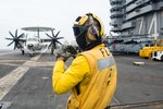160615-N-GZ947-047 PHILIPPINE SEA (June 15, 2016) Aviation Boatswain's Mate (Handling) 3rd Class Jarrett Hopkins, from Houston, directs an E-2C Hawkeye assigned to the Golden Hawks of Airborne Early Warning Squadron (VAW) 112 on USS John C. Stennis' (CVN 74) flight deck during Malabar 2016. A trilateral maritime exercise, Malabar is designed to enhance dynamic cooperation between the Indian Navy, Japanese Maritime Self-Defense Force (JMSDF) and U.S. Navy forces in the Indo-Asia-Pacific. (U.S. Navy photo by Mass Communication Specialist 3rd Class Kenneth Rodriguez Santiago/Released)