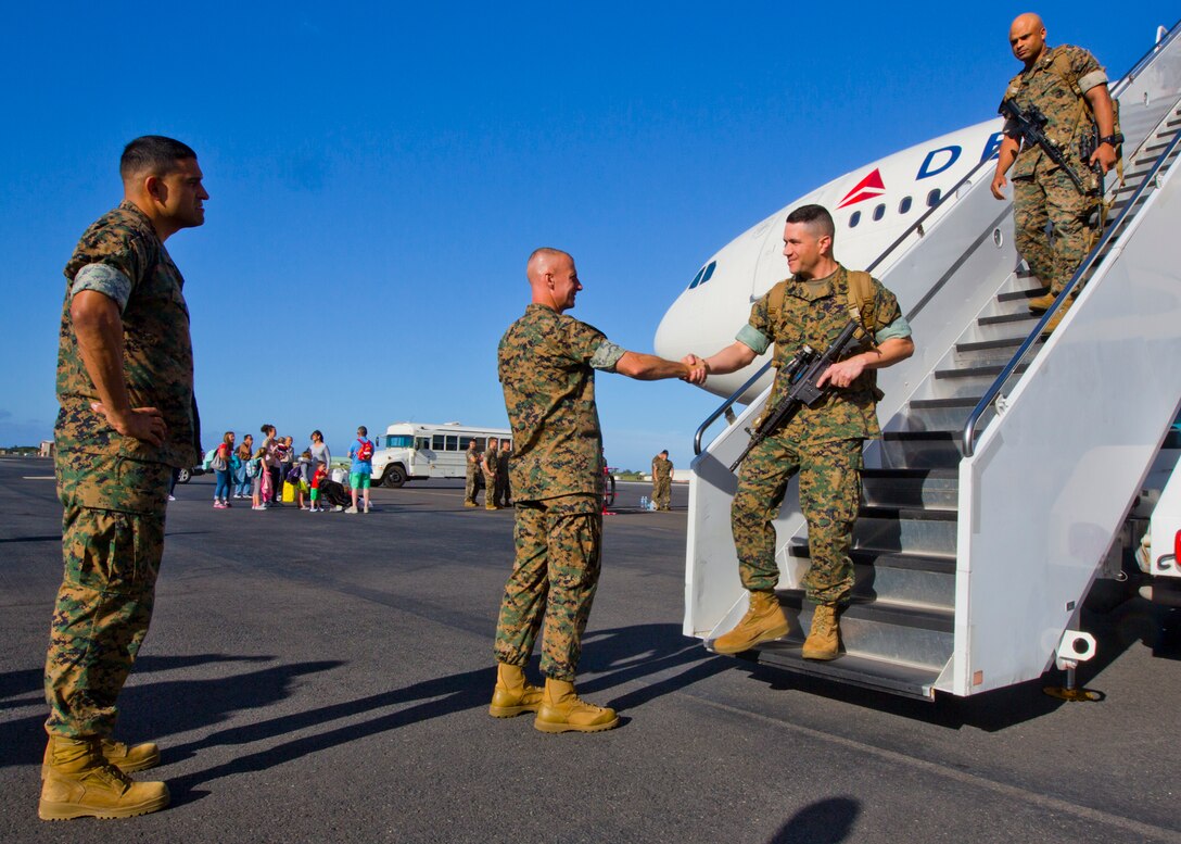 Sergeant Major Alfonso Via (left) and Colonel Carl Cooper (middle)  greet Sergeant Major Matthew Fouss  and Lieutenant Colonel Quintin Jones returning from Okinawa, Japan.  The 3d Marine Regiment sergeant major and commanding officer traveled to Joint Base Pearl Harbor Hickam to welcome the commanding officer and sergeant major of 1st Battalion, 3d Marines June 13, 2016 after a successful Unit Deployment Program as forward deplohyed forces of 3d Marine Division. (U.S. Marine Corps photo by Cpl. Ricky S. Gomez/Released)