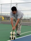 Ruben Reyes, Renner Sports Surfaces foreman, outlines painting areas for the multipurpose sport courts at Ellsworth Air Force Base, S.D., June 14, 2016. The court can be used for different activities including tennis, basketball and volleyball, each requiring its own set of lines. (U.S. Air Force photo by Airman Donald Knechtel/Released) 