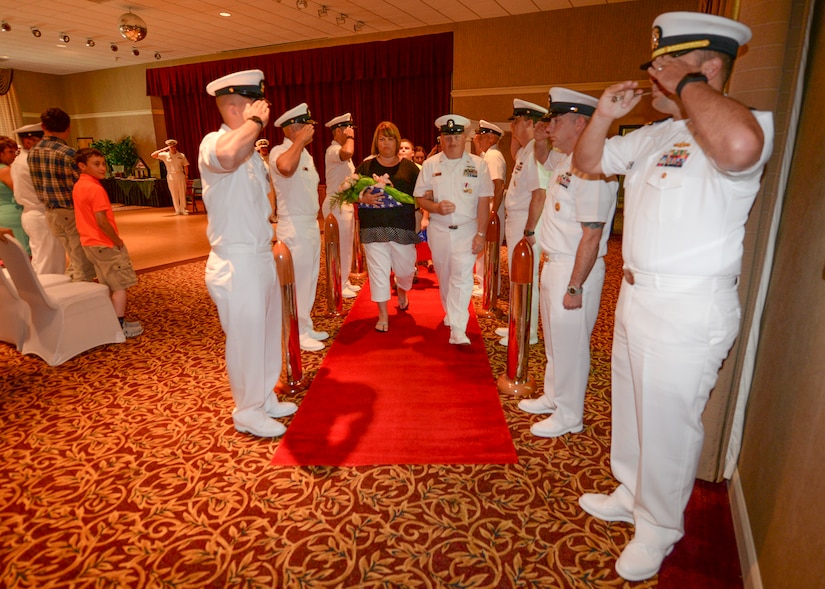 Command Master Chief Joseph Gardner and his wife, Jacque, are piped ashore at the conclusion of his retirement ceremony, June 10, 2016, at the Joint Base Charleston – Weapons Station, Red Bank Club. Gardner served for more than 28 years in the United States Navy. (U.S. Navy Photo by Mass Communication Specialist Sean M. Stafford/Released)