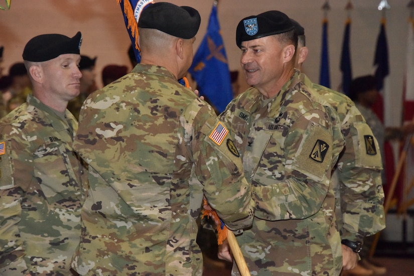 U.S. Army Col. Julius A. Rigole, 128th Aviation Brigade commander, passes the guidon of the1st Battalion, 222nd Aviation Regiment to Lt. Col. Michael A. Sines, 1st Bn., 222nd Avn. Reg. commander, at Ft. Eustis, Va., June 7, 2016.  The outgoing commander, Lt. Col. Christopher Stallings, is slated to serve on the Joint Staff at the Pentagon. (U.S. Army photo by Rodney E. Speed)