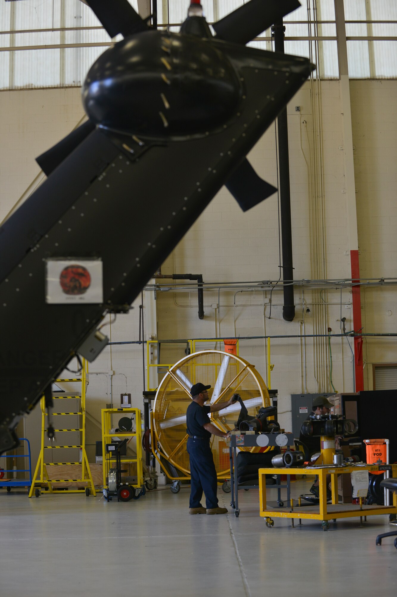 Gilberto Rodriguez, U.S. Falcon Inc. helicopter mechanic, reassembles the rotor blade of a CH-47D Chinook at Ft. Eustis, Va., June 13, 2016. The mechanics at the Ft. Eustis Falcon facility, provide repair, inspection and maintenance for Navy, Marine and Army training, mission and test-pilot aircraft. (U.S. Air Force photo by Staff Sgt. Natasha Stannard/Released)  