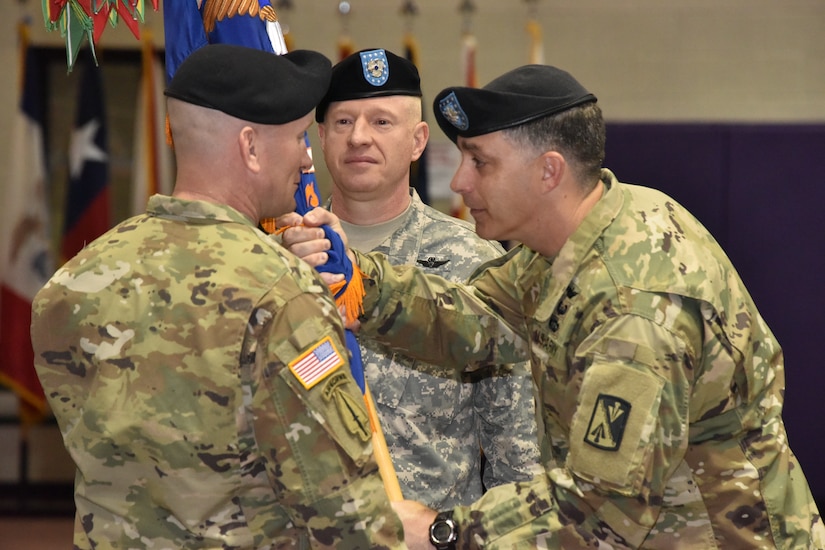 U.S. Army Lt. Col. Christopher Stallings, commander of the the1st Battalion, 222nd Aviation Regiment, passes the guidon of the regiment to Command Sgt. Maj. William E. Behrens, 1st Bn., 222nd Avn. Reg. command sergeant major, at Joint Base Langley-Eustis, June 3, 2016. As the Command Sgt. Maj., Behrens will be responsible for the battalion that runs Advanced Individual Training for the Army’s newest helicopter pilots. (U.S. Army photo by Rodney E. Speed)