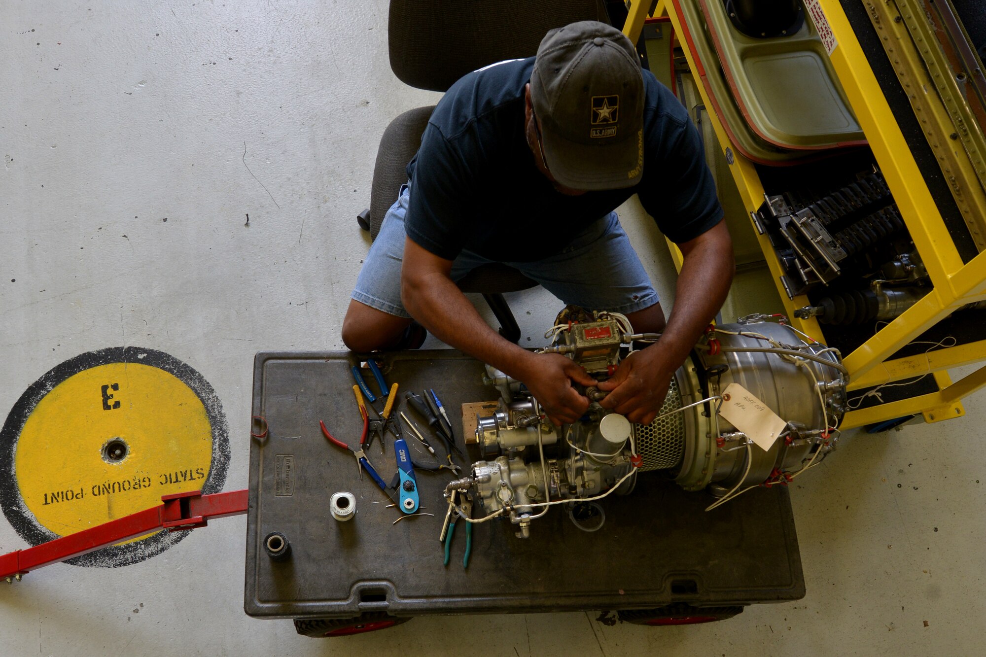 Darren Syler, U.S. Falcon Inc. maintenance technician, checks wires on an auxiliary power unit at Ft. Eusits, Va., June 13, 2016. Ensuring the wires are properly connected helps reduce the risks of installation issues. (U.S. Air Force photo by Staff Sgt. Natasha Stannard/Released)  