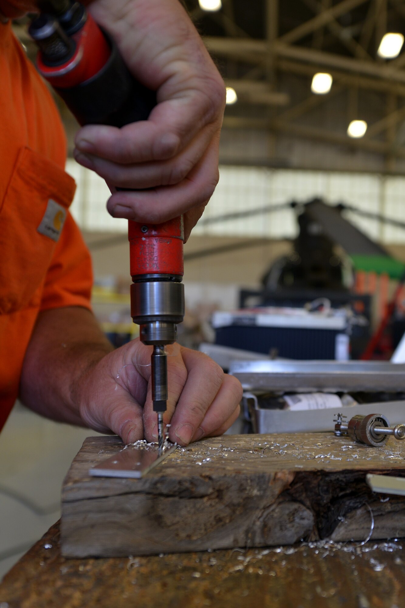 Kenneth Godney, U.S. Falcon Inc. sheet metal technician, drills mounting holes onto a satellite radio tray at Ft. Eusits, Va., June 13, 2016. As a sheet metal mechanic, Godney prepares various pieces of equipment for installation, maintenance and repair of aircraft. (U.S. Air Force photo by Staff Sgt. Natasha Stannard/Released)   