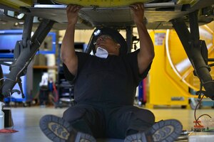 Kenneth Menifee, U.S. Falcon Inc. structures mechanic, modifies the ammunition bay doors configuration from an AH-64D to an AH-64E Apache trainer helicopter at Ft. Eusits, Va., June 13, 2016. Falcon is in the process of converting all of the 128th Aviation Brigade’s Apache trainers to the e-model as a way to keep training up-to-date. (U.S. Air Force photo by Staff Sgt. Natasha Stannard/Released)  