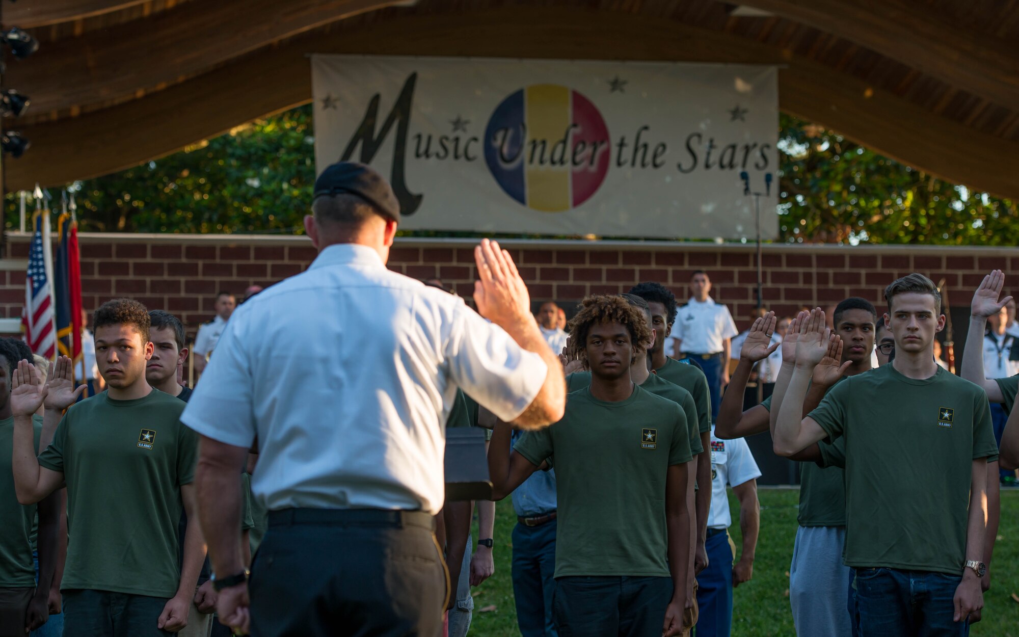 U.S. Army Brig. Gen. Robert J. Ulses, Training and Doctrine Command Deputy Chief of Staff, gives the oath of enlistment to Army recruits during Music Under the Stars in Magnolia Park at Fort Eustis, Va., June 9, 2016. The future Soldiers took the oath as part of Fort Eustis’ 241st Army Birthday celebration. (U.S. Air Force photo by Staff Sgt. J.D. Strong II)