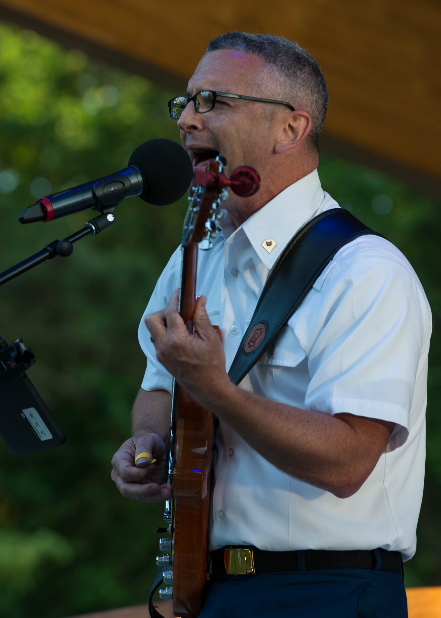 U.S. Army Spc. Andre Badeaux, Training and Doctrine Command Band guitarist, performs “Soldier”, by Gavin Degraw, during Music Under the Stars in Magnolia Park at Fort Eustis, Va., June 9, 2016. In addition to “Soldier”, the band played the song for each U.S. branch of service, showing patronage for their comrades, as they closed the ceremony.  (U.S. Air Force photo by Staff Sgt. J.D. Strong II)