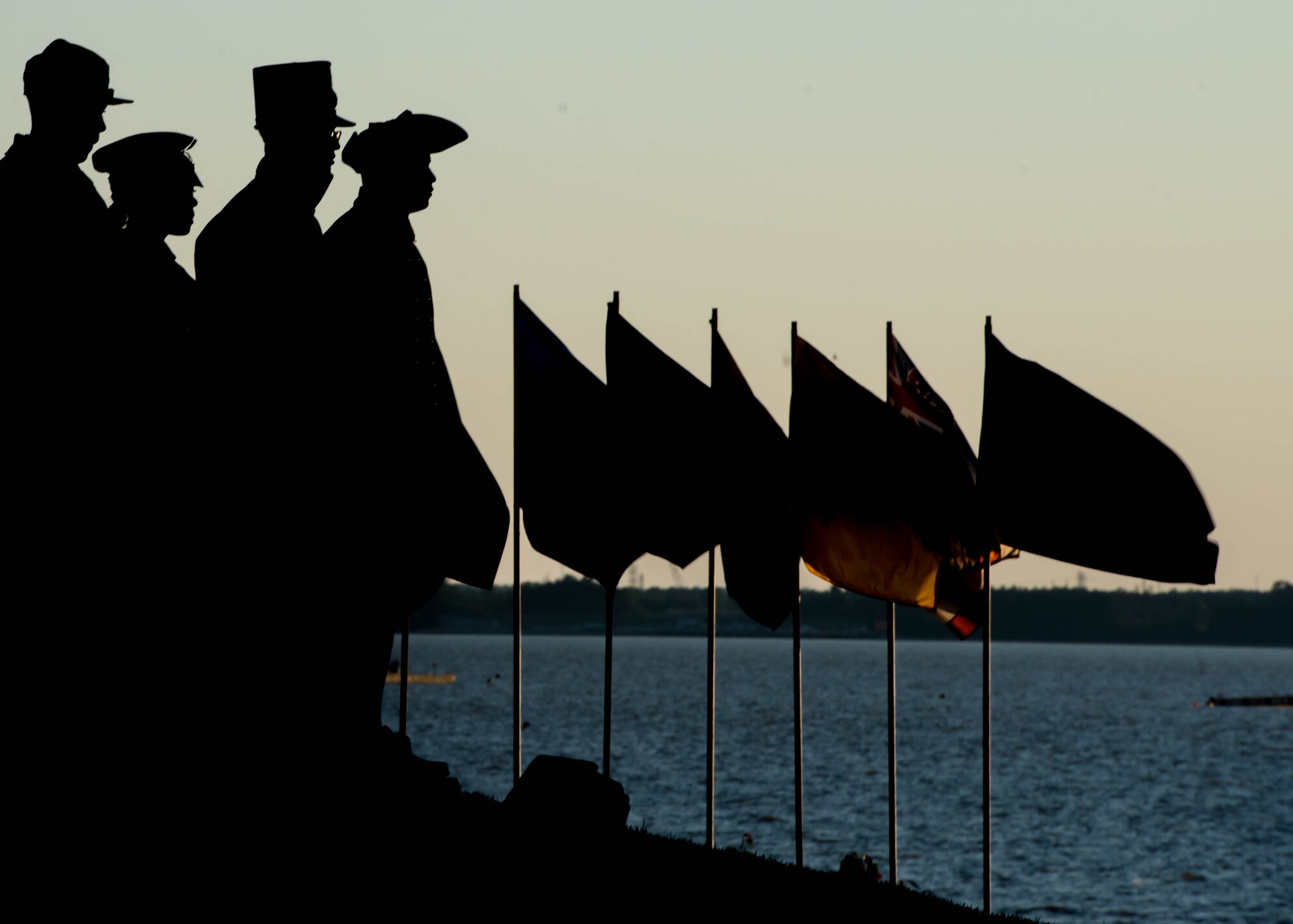 U.S. Army soldiers, wearing Army uniforms from different time periods, participate in the streamer ceremony during Music Under the Stars in Magnolia Park at Fort Eustis, Va., June 9, 2016. Fourteen different uniforms worn throughout the Army’s 241 years of existence were displayed, including uniforms worn in the Revolutionary War, Desert Storm and Operation Enduring Freedom. (U.S. Air Force photo by Staff Sgt. J.D. Strong II) 