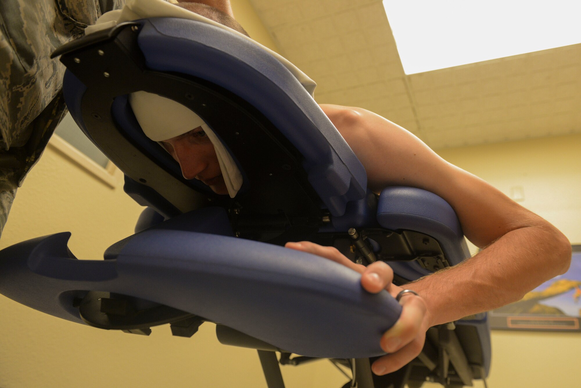 Staff Sgt. Richard Brocker, NCO in charge of the armory for the 91st Security Support Squadron, undergoes a physical therapy consolation at Minot Air Force Base, N.D., June 10, 2016. Brocker received thoracic manipulation to increase mobility of his mid-back and trigger point dry needling to decrease muscle tension in his upper trapezius. (U.S. Air Force photo/Airman 1st Class Jessica Weissman)