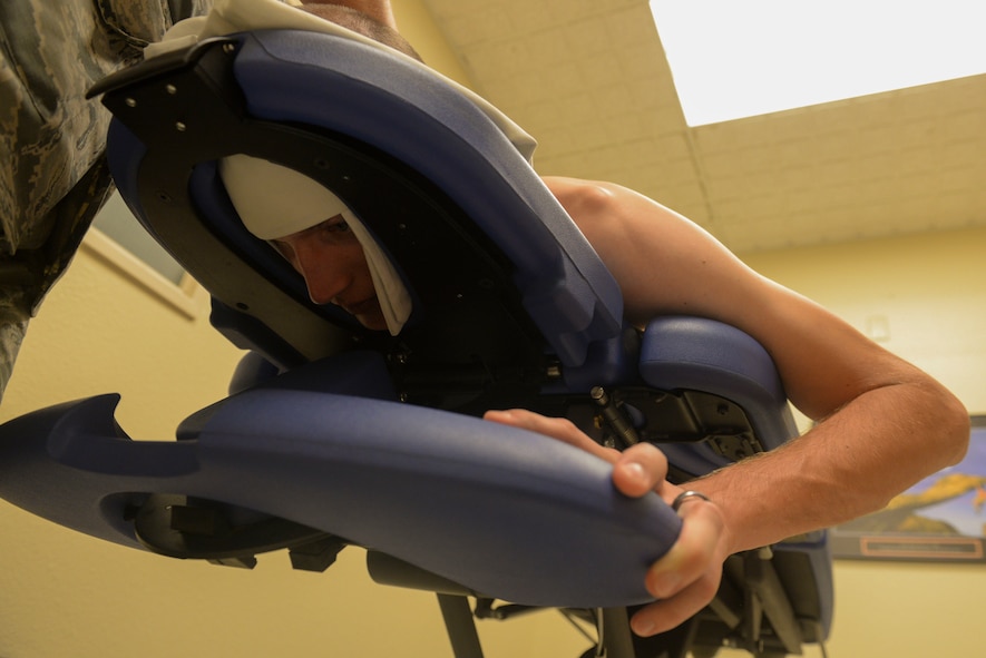 Staff Sgt. Richard Brocker, NCO in charge of the armory for the 91st Security Support Squadron, undergoes a physical therapy consolation at Minot Air Force Base, N.D., June 10, 2016. Brocker received thoracic manipulation to increase mobility of his mid-back and trigger point dry needling to decrease muscle tension in his upper trapezius. (U.S. Air Force photo/Airman 1st Class Jessica Weissman)