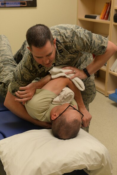Capt. Justin Gleed, a physical therapist assigned to the 5th Medical Operations Squadron at Minot Air Force Base, N.D., performs a thoracic manipulation on a patient June 10, 2016. This procedure increases mobility of the mid-back. (U.S. Air Force photo/Airman 1st Class Jessica Weissman)