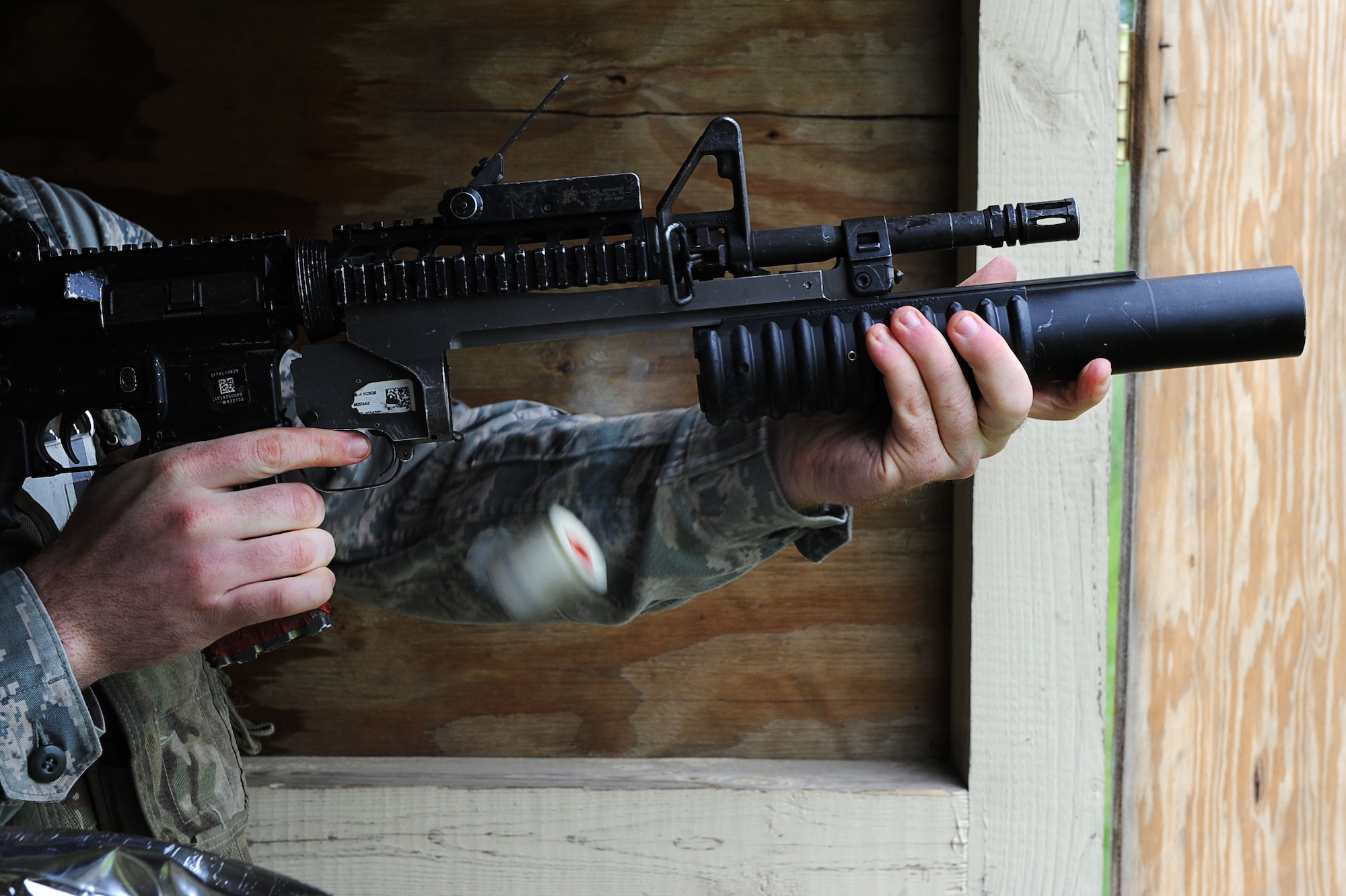 A defender from Team Minot releases an M-203 grenade launcher cartridge after firing a round at Minot Air Force Base, N.D., June 15, 2016. Prior to firing, the defenders learned how to break down the M-203 and clean it. To carry the weapon, defenders must qualify annually. (U.S. Air Force photo/Senior Airman Kristoffer Kaubisch)