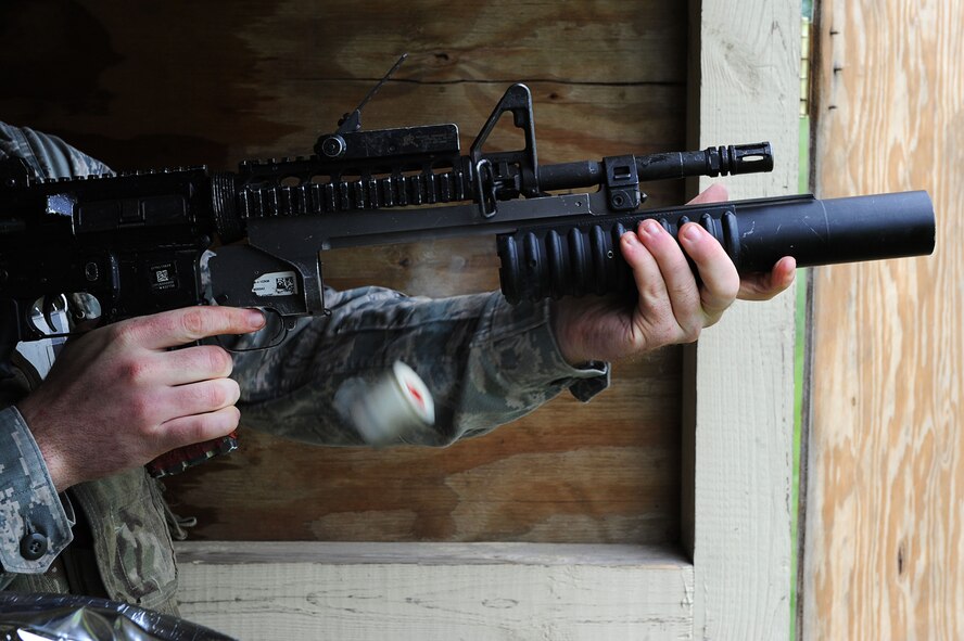 A defender from Team Minot releases an M-203 grenade launcher cartridge after firing a round at Minot Air Force Base, N.D., June 15, 2016. Prior to firing, the defenders learned how to break down the M-203 and clean it. To carry the weapon, defenders must qualify annually. (U.S. Air Force photo/Senior Airman Kristoffer Kaubisch)